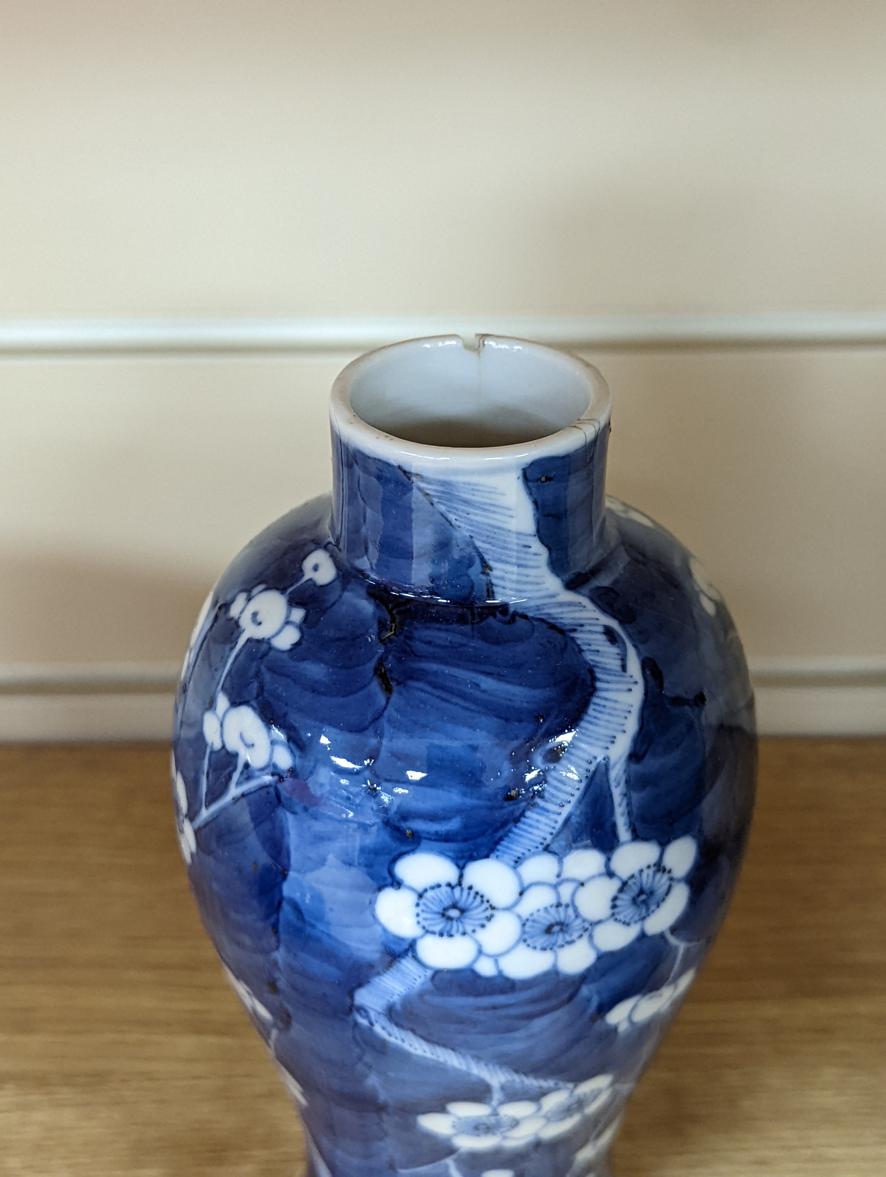 A pair of 19th century Chinese blue and white vases, a prunus vase and cover and a similar jar (4), pair of vases 24 cms high.